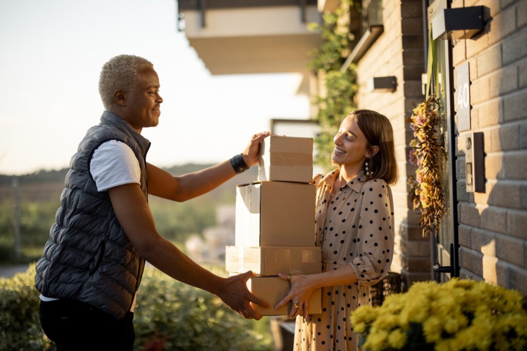 Delivery man giving parcels to caucasian woman